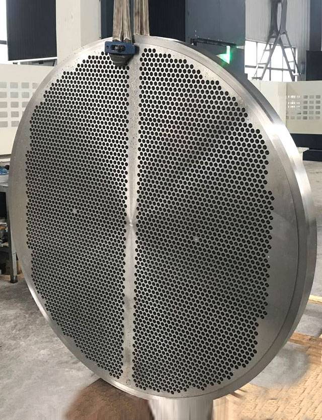 Steel tube sheet with holes drilled in it